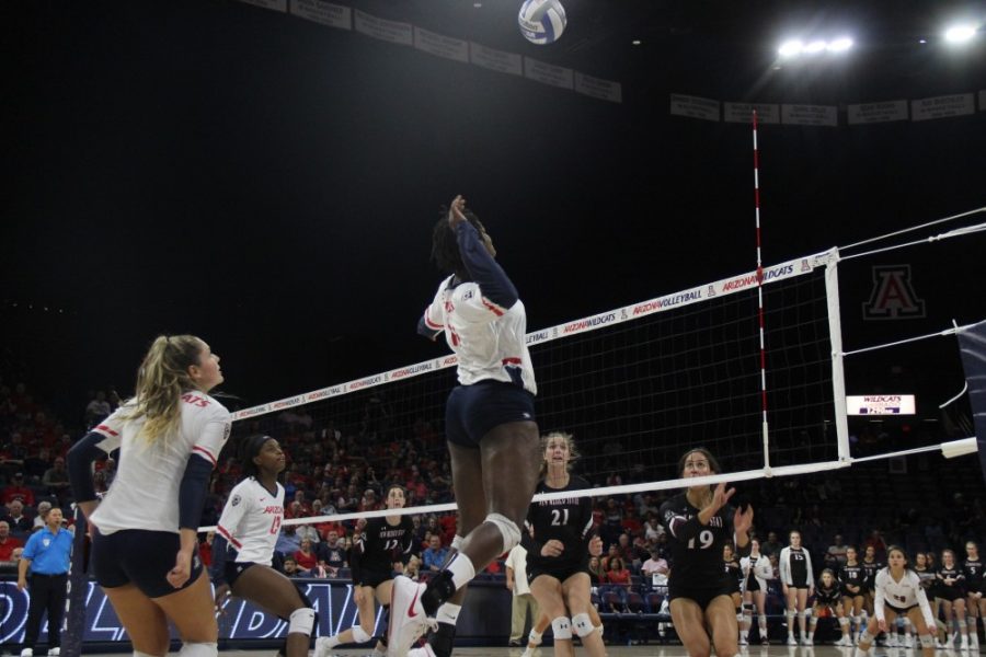 Redshirt junior Elizabeth Shelton (17) jumps high to spike the ball against New Mexico State University.