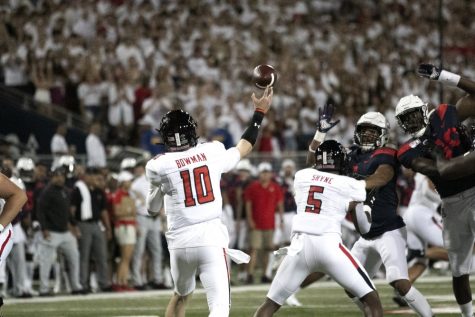 Texas Tech quarterback Alan Bowman (10) throws the ball down the line to his teammate, looking for a first down.