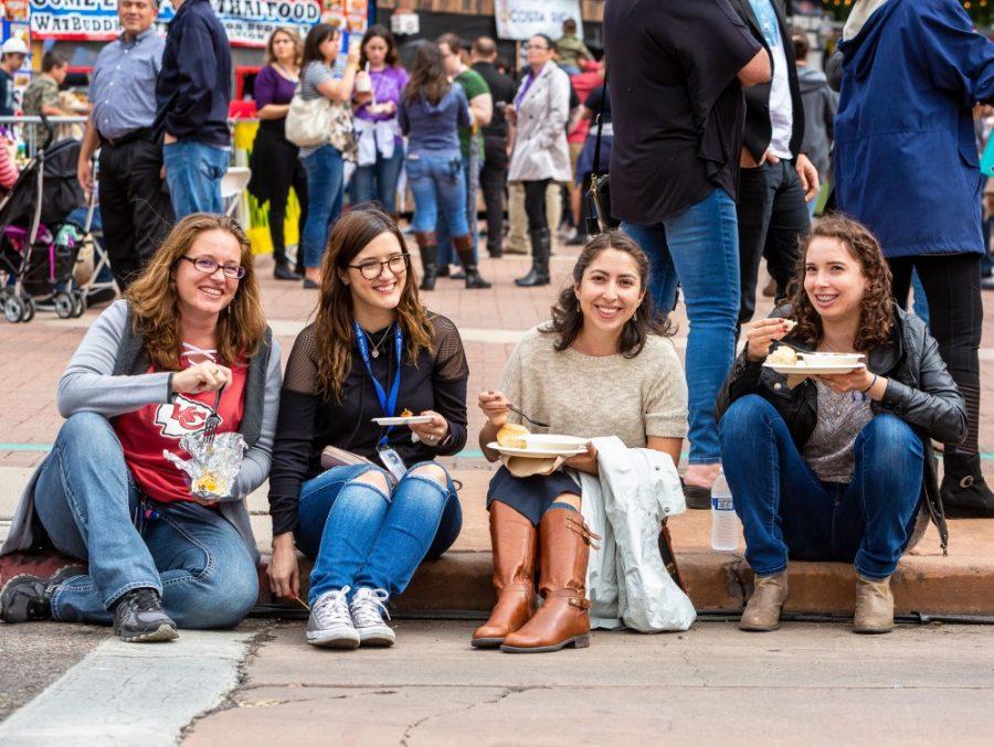 A group enjoys some food at the Tucson Meet Yourself Folk Festival, returning to Tucson on October 11. The Festival brings together over 50 food vendors representing 30 countries.