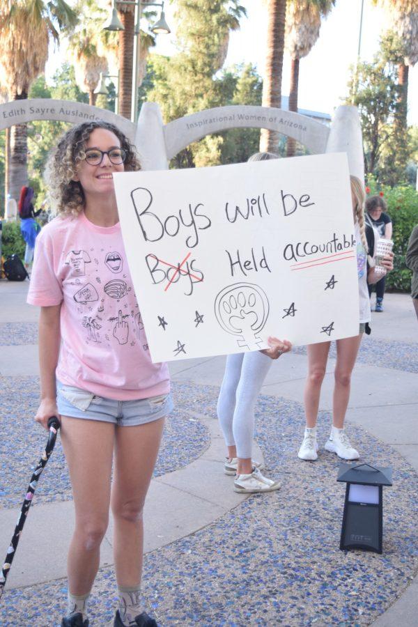 A SlutWalk attendee with the sign they made to carry during the march on Nov. 13, 2019. This year, the walk started at the Women’s Plaza of Honor at the University of Arizona and ended at the Rialto Theater.