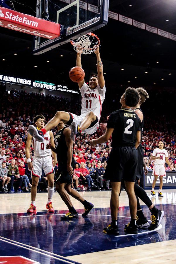 Arizona+junior+Ira+Lee+%2811%29+scores+another+point+for+the+Wildcats+by+dunking+during+the+second+half.+