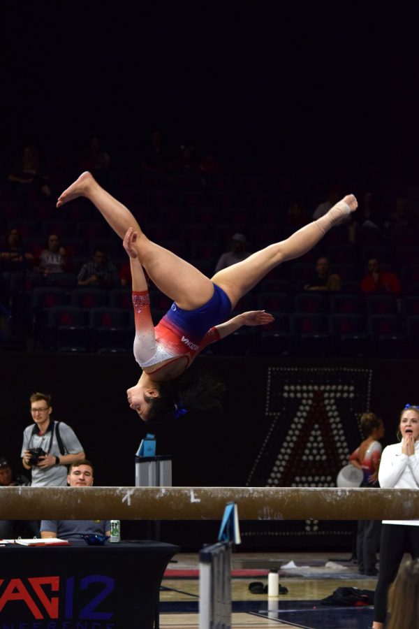 Malia+Hargrove+does+a+flip+on+the+balance+beam+at+the+Feb.+1%2C+2020%2C+meet+against+University+of+Utah.+Hargrove+has+been+training+as+a+gymnast+for+11+years.