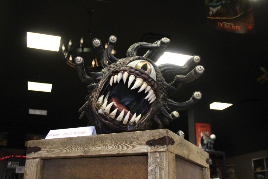 A beholder, sits on top of a box welcoming in guests to the Tucson mall location in 2019. The beholder has since moved and now sits behind the window staring at everyone window shopping.
