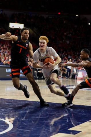 Nico Mannion (1) tries to dribble past Sean Miller-Moore (1) during the second half of the Arizona-Oregon State game.