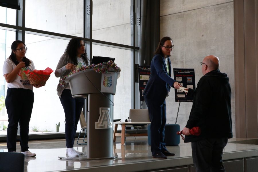 Lydia Kennedy, Senior Director from Office of Diversity and Inclusion hands out a raffle prize at the second annual UAHS LGBTQ and National Symposium Community Health Fair in Tucson, Ariz., Saturday, Feb. 22, 2020. 