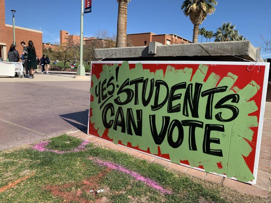 A sign leaning on a ledge on the UA Mall encourages students to vote. Many of the booths at the 2019 club fair on the Mall stressed the importance of registering to vote on time.