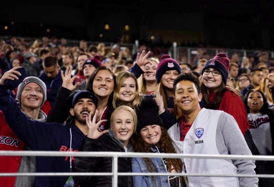 Members of the Zona Zoo Crew smile for a picture during halftime at an Arizona football game. 