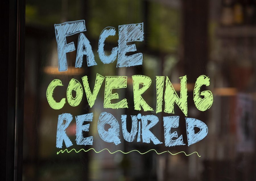 A sign at the entrance of Hopdoddy Burger Bar on South Congress Avenue requires guests to wear a mask due to the coronavirus pandemic. (Jay Janner/American-Statesman/MCT)