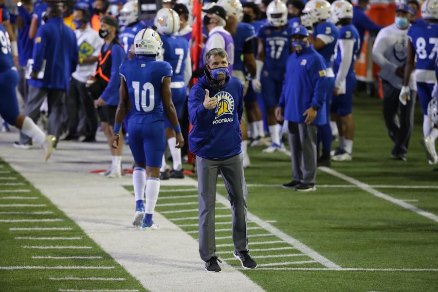 San Jose Sate head coach Brent Brennan stands on the sideline and signals to one of his players. (Courtesy of San Jose State University Athletics.)