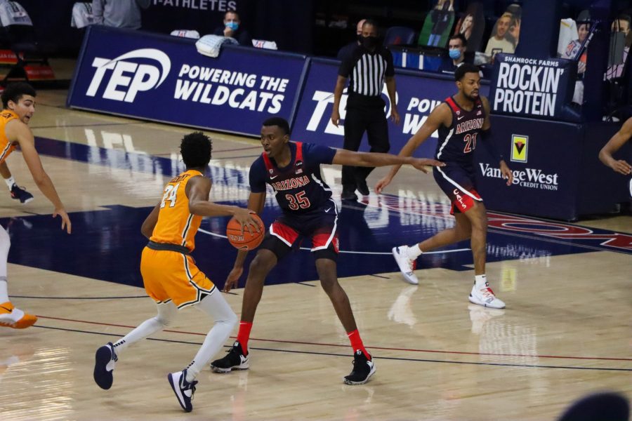 <p>Christian Koloko, a sophomore on the University of Arizona’s men’s basketball team, plays defense on a UTEP player in the McKale Memorial Center, Saturday, Dec 12, 2020. The Wildcats went on to win the game 69-61.</p>