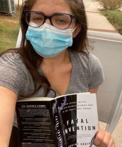 Jacquelyn Hoffman, a member of the shared shelf book club poses with this semesters book. (Courtesy Jacquelyn Hoffman)
