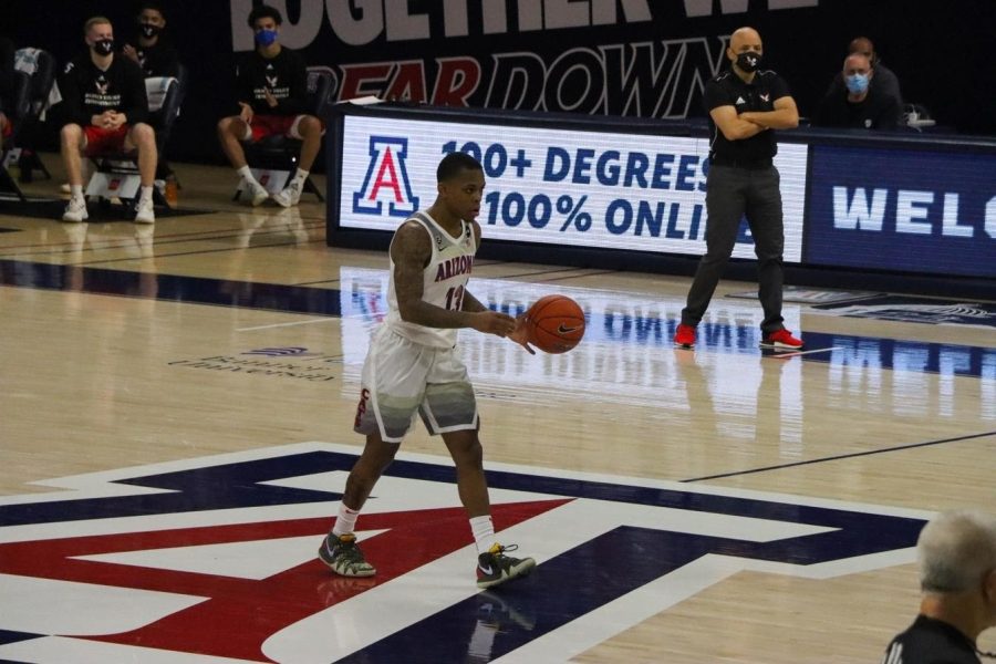 James Akinjo, a junior on the University of Arizona men’s basketball team, dribbles down the court in McKale Center, Saturday, Dec. 5, 2020.