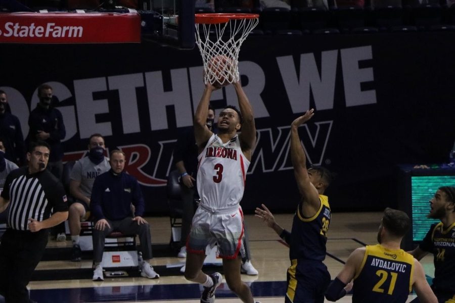 Jemarl Baker Jr., a redshirt junior on the University of Arizona’s men’s basketball team, drives the hoop and takes a contested layup over a Northern Arizona player in the McKale Memorial Center, Monday, Dec 7, 2020.