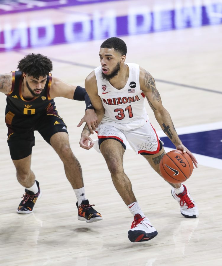 Arizona guard Terrell Brown Jr. dribbles past ASU defender Holland Woods on Monday, Jan. 25, 2021 in McKale Center in Tucson, Ariz. The Wildcats went on to win 80-67. (Courtesy of Mike Christy/Arizona Athletics)