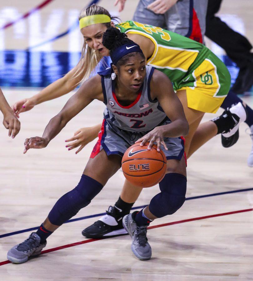 Arizona point guard Aari McDonald drives to the basket and evades an Oregon defender on Thursday, Jan. 14, 2021. The Wildcats went on to to win the game 57-41. (Courtesy of Mike Christy/Arizona Athletics)