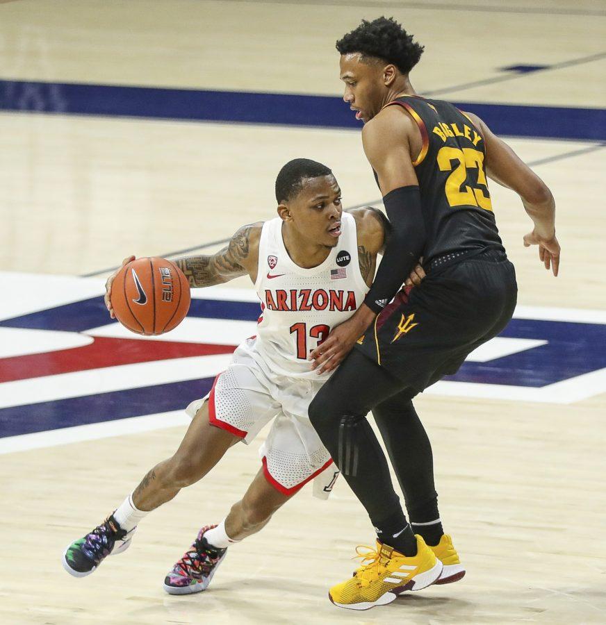 Arizona point guard James Akinjo dribbles past Arizona States Marcus Bagley on Monday, Jan. 25, 2021, in McKale Center in Tucson, Ariz. The Wildcats went on to win 80-67. (Courtesy of Mike Christy/Arizona Athletics)