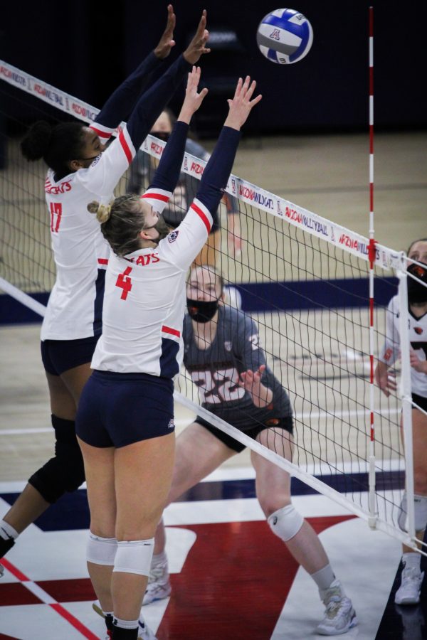 Arizona volleyball setter Emery Hermon and middle blocker China Rai Crouch jump up to block a shot against Oregon State on Friday, Feb. 19, 2021 in Tucson, Ariz. in McKale Center. The Wildcats went on to sweep the Beavers 3-0.  