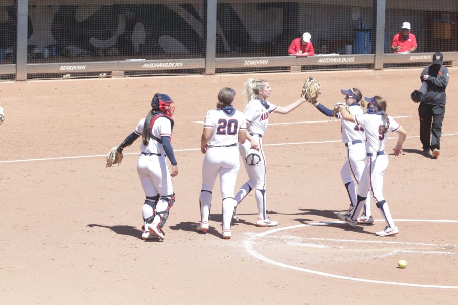 Members of the Arizona women’s softball team high five following a home run during a game on Sunday, Mar. 28 in Tucson, Ariz. The Wildcats played Oregon State and won 7 to 5. 