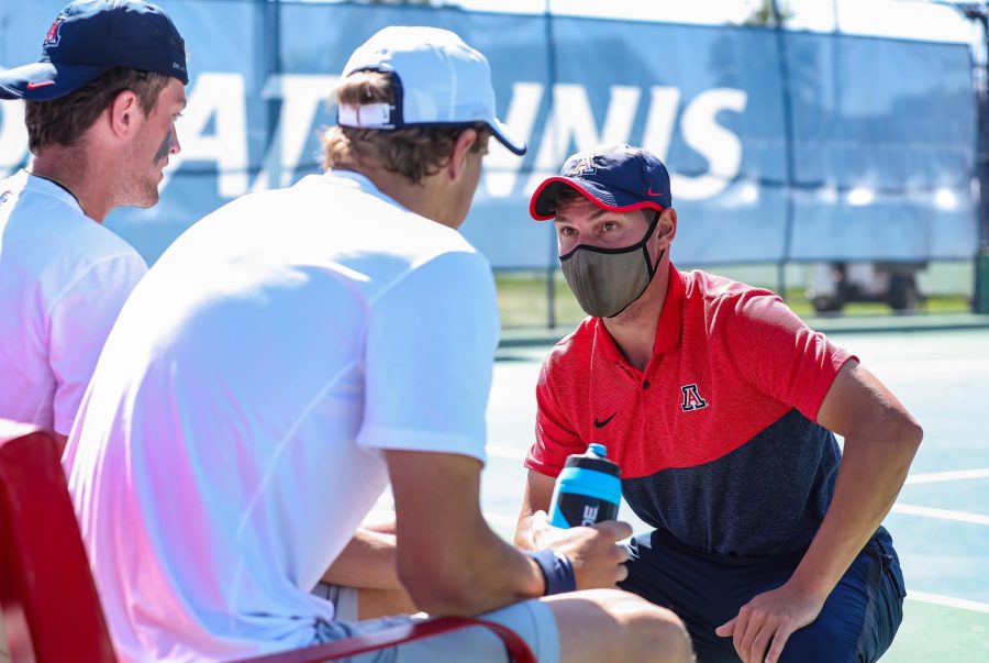 Mitch Stewart, volunteer coach, Igor Karpovets, Jett Middleton at the men’s tennis match against New Mexico at Lanelle Robson Tennis Center on March 1, 2021. (Courtesy of Mike Christy/Arizona Athletics.)