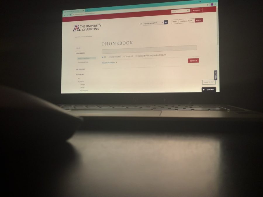 Photo illustration of the UA Phonebook website open on a laptop.  