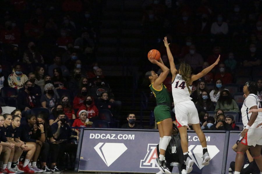 Sam Thomas (14) blocks an opponent during a game on Thursday, Dec. 9. at McKale Center. The match against North Dakota State ended in a victory and the Wildcats remain undefeated. 