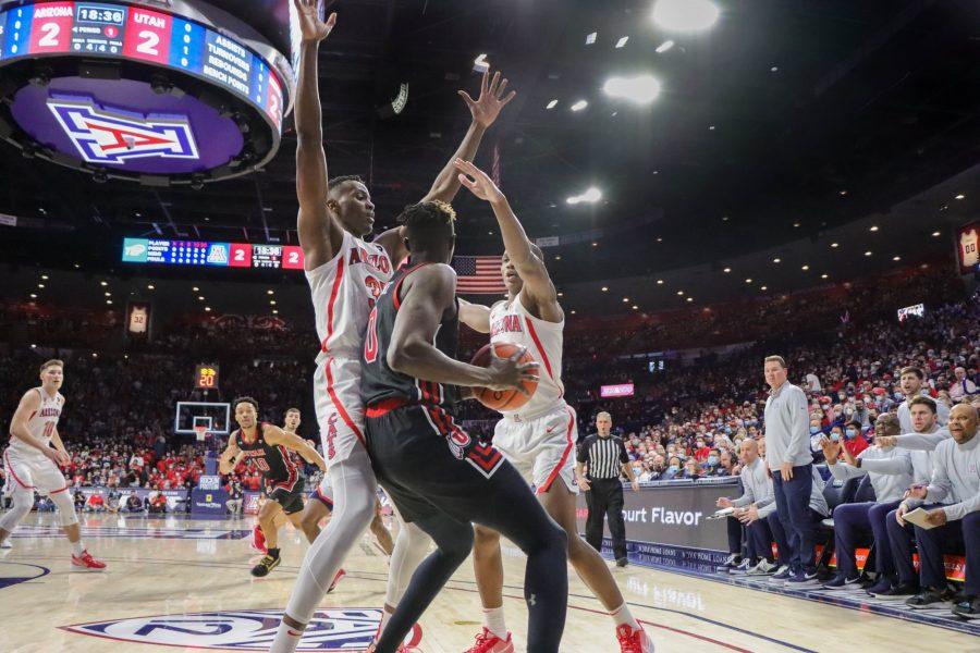 Teammates Chirstain Koloko and Bennedict Mathurin of the Univeritys of Arizona mens Basketball team double cover a Univeristy of Utah player on Saturday Jan. 15 at the Mckale Center. The wildcats would lead going into half 34-31