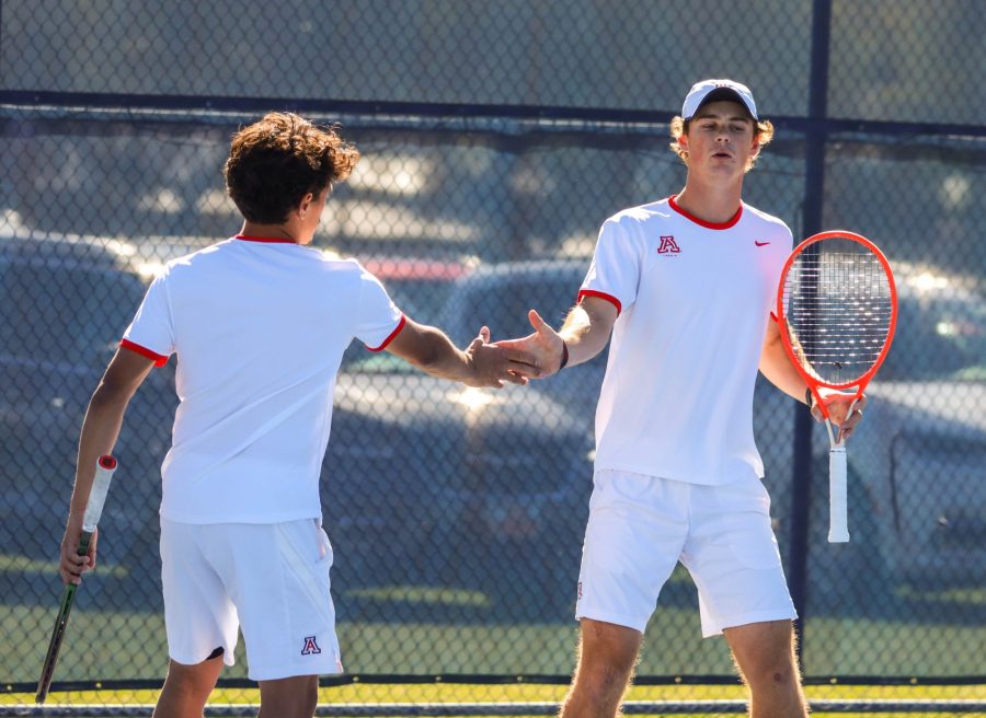 Teammates+Carlos+Hassey+and+Nick+Lagaev+exchange+a+high+five+after+gaining+a+point+on+their+opponent+the+University+of+San+Deigo+on+Feb.+4+at+the+Robson+Tennis+Center.+The+pair+went+on+to+win+their+first+match.
