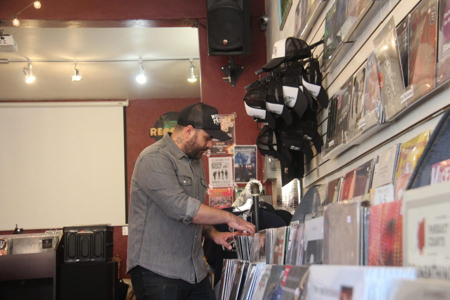 Kellen Fortier, co-owner of Wooden Tooth Records, organizes records. 
