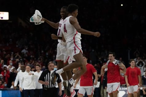 Bennedict Mathurin (0) and Dalen Terry (4) celebrate their win against UCLA in McKale Center on Feb. 3. The Arizona men's basketball team won the game 76-66.