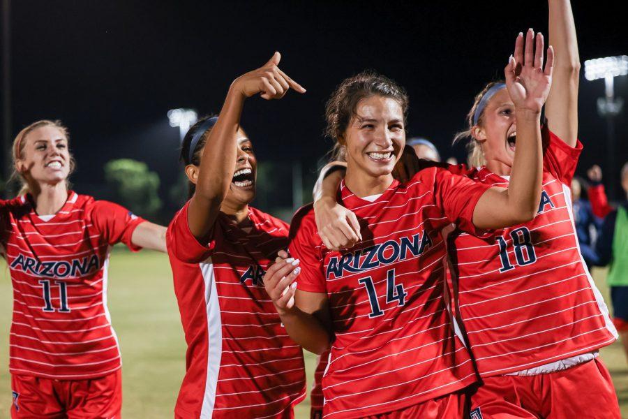 Jill Aguilera (14) celebrates with her teammates Ava McCray (3), Madison Goerlinger (18) and Quincy Bonds (11) on Nov. 5, 2021, in Tucson. Aguilera scored the winning goal in overtime to beat ASU 2-1. (Photo courtesy of Ary Frank / Arizona Athletics)