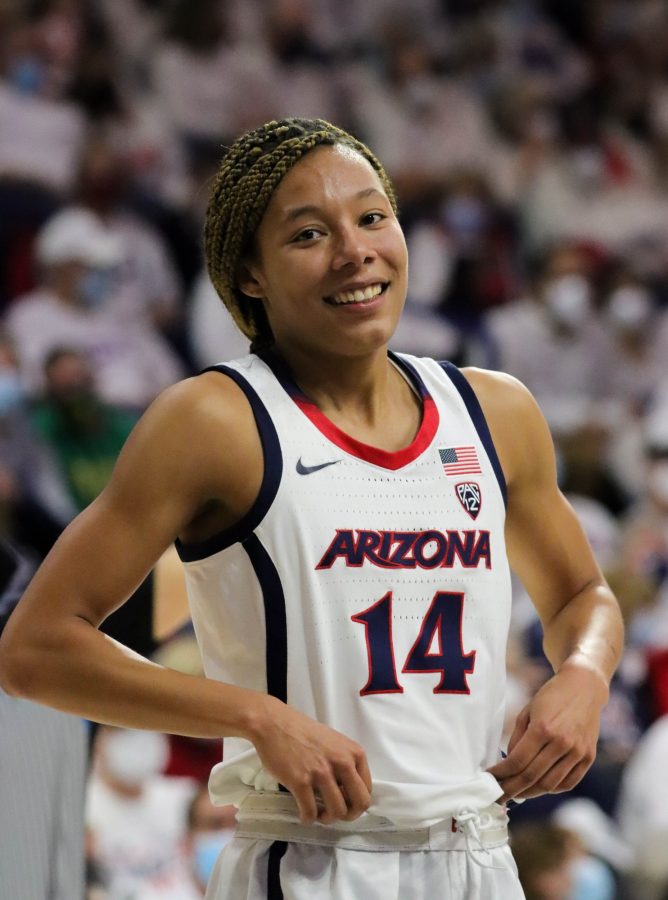 Sam Thomas, a forward on the University of Arizona womans basketball team, smiles after a teammates score on Friday, Feb. 4, in McKale Center. The Wildcats would lead into half 30-24.