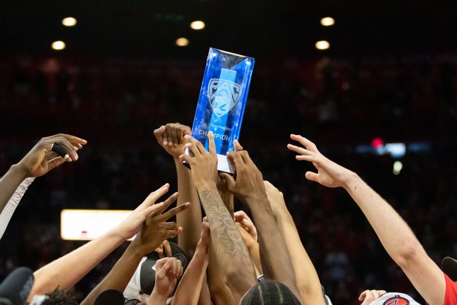 The Arizona mens basketball team holds up the Pac-12 trophy after winning the game against University of California Berkeley on March 5 in McKale Center. The Wildcats won the game 89-61.