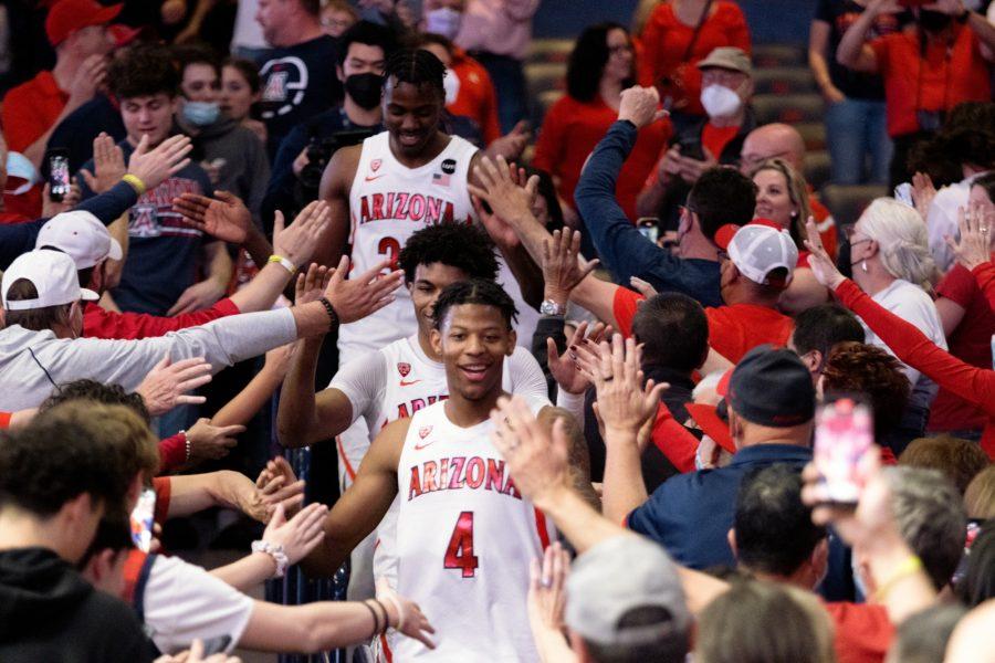 The+Arizona+mens+basketball+team+celebrates+after+its+win+against+the+University+of+California%2C+Berkeley%2C+earlier+this+month%2C+winning+it+the+Pac-12+title+and+trophy.+With+the+Pac-12+champions+banner+and+trophy%2C+the+Wildcats+would+cut+down+the+basketball+net+and+run+through+the+crowd+to+memorialize+the+date+in+Arizona+basketball+history.%26nbsp%3B
