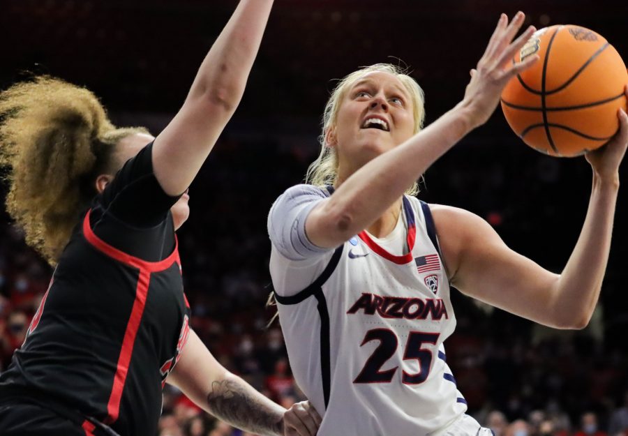 Cate Reese, a forward on the Arizona womens basketball team, spins away from a defender and draws a foul during her shot on March 19 in McKale Center. The Wildcats would win the game 72-67.
