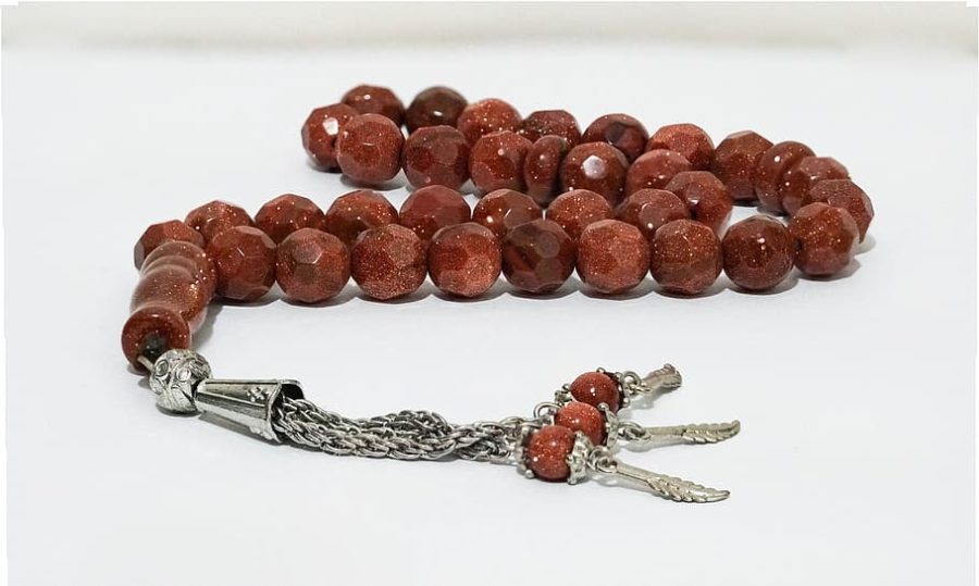 Prayer beads on a table. Photo Credit: Image retrieved via Piqsels (public domain).