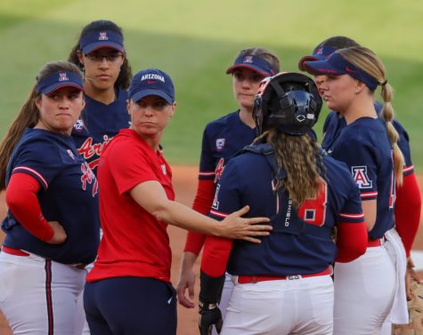 Head coach Caitlin Lowe has a meeting at the mound with her infielders on Friday, April 15, at Rita Hillenbrand Memorial Stadium. The Wildcats would lose in five innings 11-3.