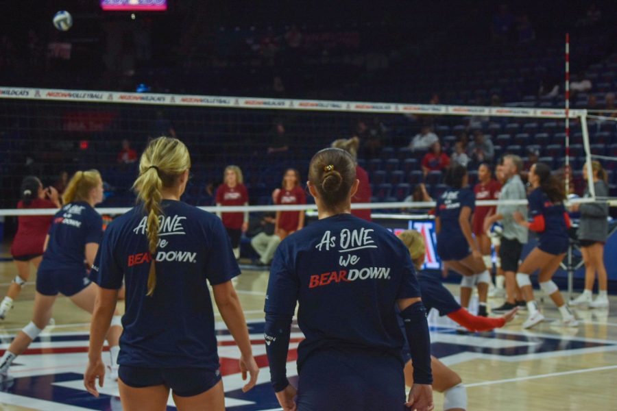 Players sport the warm up shirts of the University of Arizonas womens volleyball team. The athletes prepare for their second match in the 2022 Cactus Classic.
