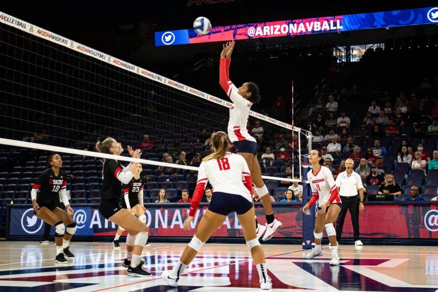 Arizona volleyball player Alayna Johnson (32) sets the ball over the net on Sept. 17 in McKale Center. The Wildcats would go undefeated in the tournament over the weekend. 