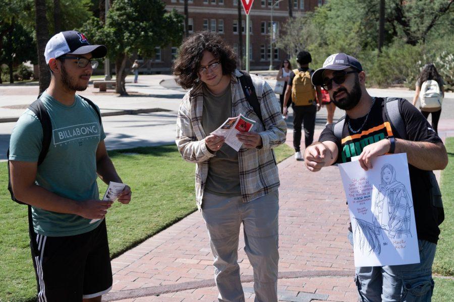 A man shares the situation in Iran with students passing by in front of Old Main. The protest was held on Sept. 30. 