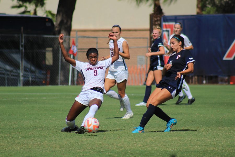 Forward, Jordan Hall, slides in to pass the ball at the Arizona womens soccer match against Pepperdine on Sunday, Sept. 11 in Tucson, Arizona. Wildcats would loose 0-2.