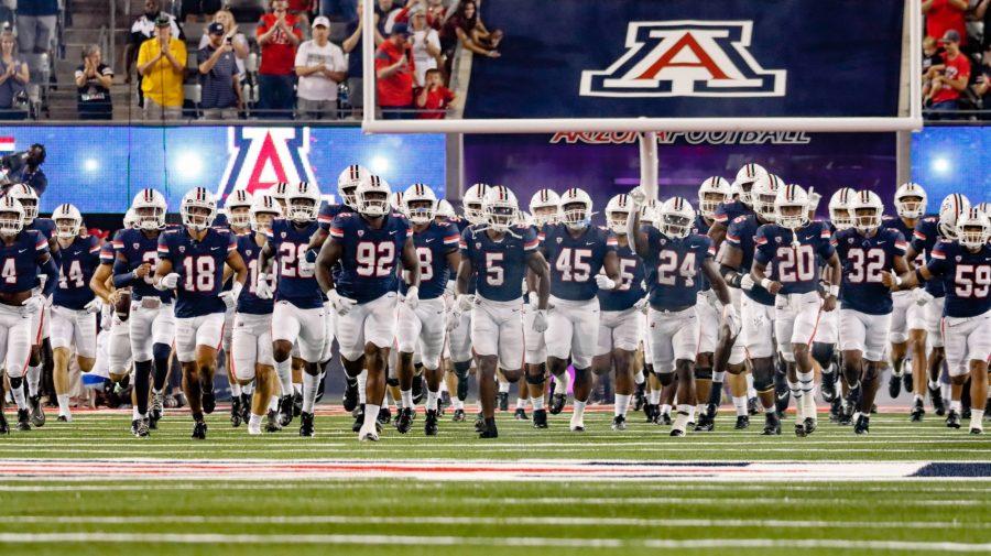 The Arizona football team runs onto the field before a game against North Dakota State University on Saturday, Sept. 17, at Arizona Stadium. The Wildcats would go on to win the game 31-28 and advance their record to 2-1. 