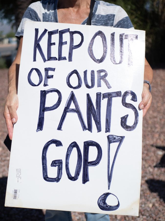 A sign saying KEEP OUT OF OUR PANTS GOP at the Womens Wave on Saturday, Oct. 8. The protest took place on the street near 5000 Broadway Blvd.