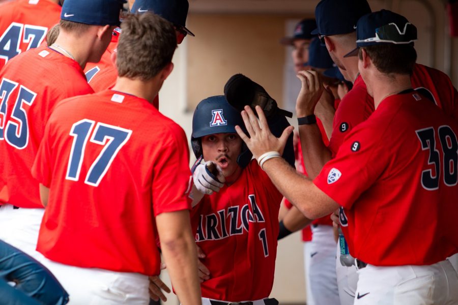 Garen Caulfield enters the dugout, receives high fives from his teammates after scoring a run in a game against Pima Community College on Oct. 15, 2022 at Hi Corbett Field. The Wildcats would go on to win 5-0.