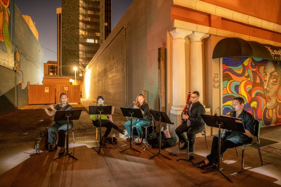 An ensemble of musicians performs near one of the murals in Downtown Tucson as part of the Musical Murals event being put on by the Fred Fox School of Music. (Photo Courtesy of Cynthia Barlow)