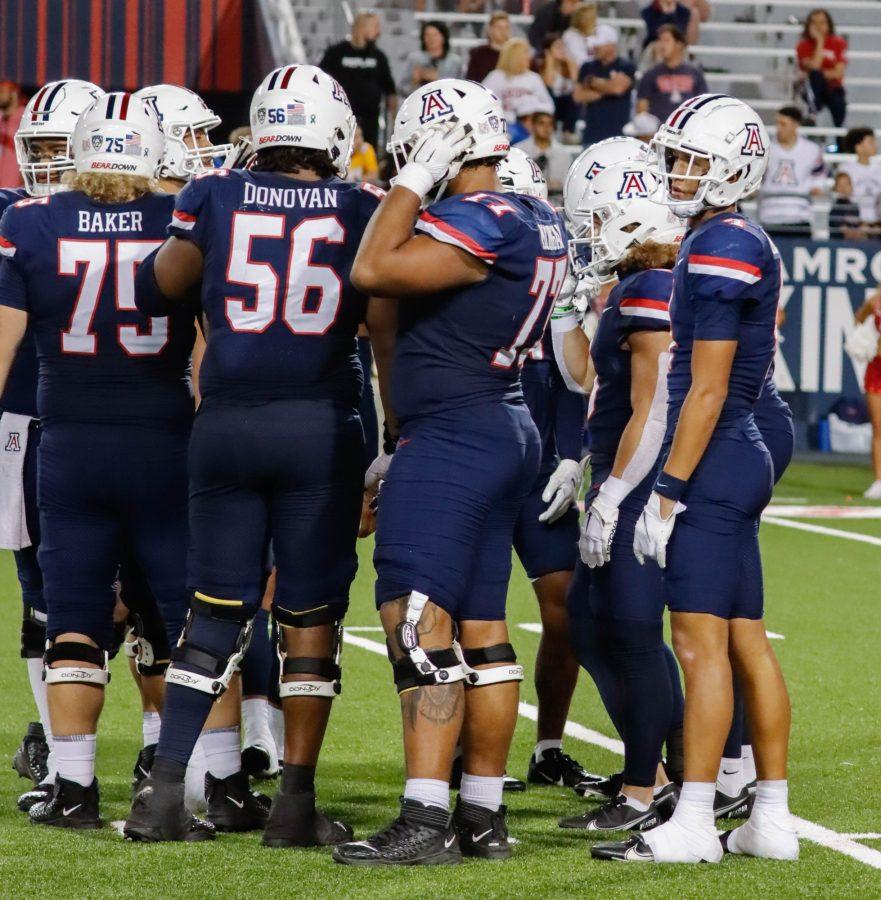 Arizona football offense stand in a huddle before a play against the University of Oregon on Oct. 8 in Arizona Stadium. The Wildcats would lose the game 22-49. 