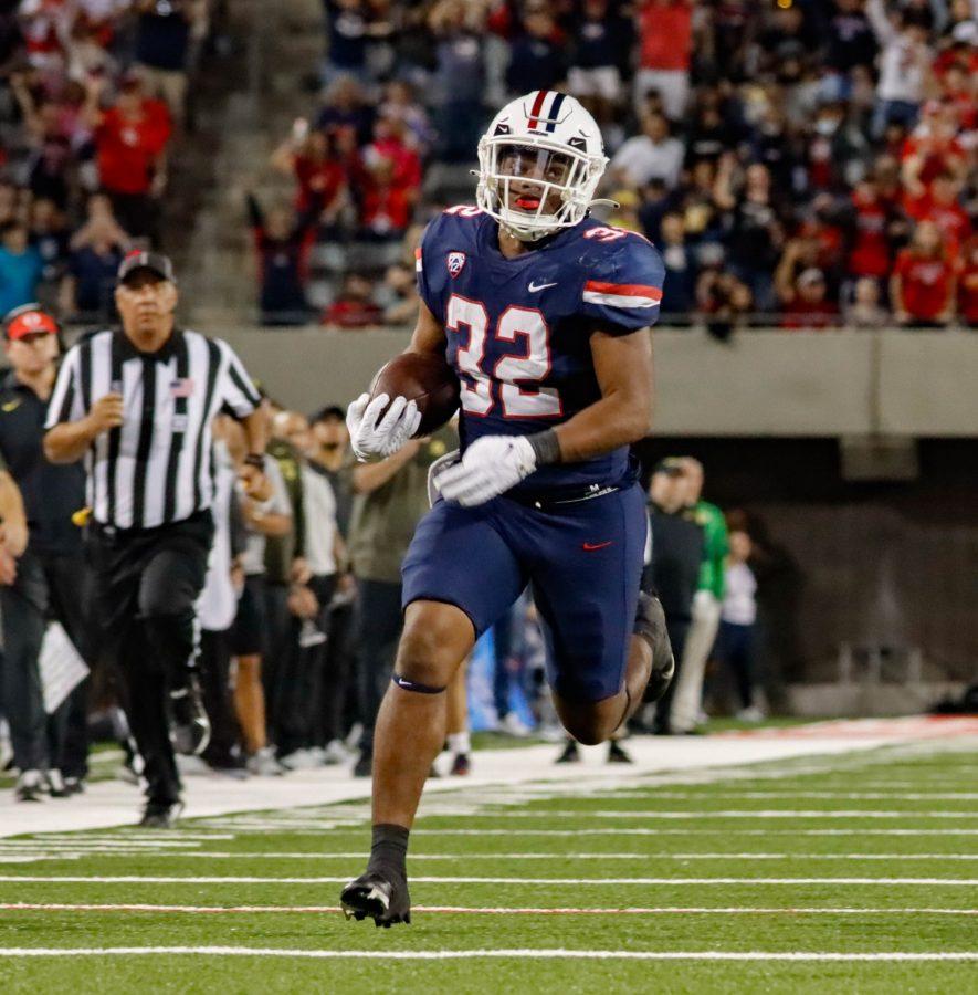 DJ Williams, a running back on the Arizona football team, scores a touchdown on a long run at Arizona Stadium on Oct. 8. The Wildcats would go on to lose the game 49-22. 