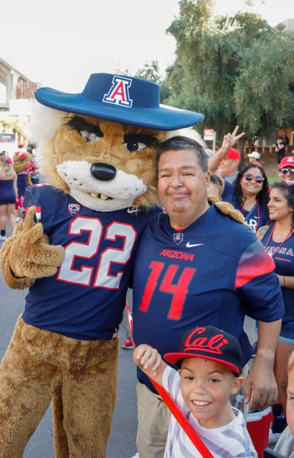 The University of Arizona mascot Wilbur poses with a fan during the Wildcat Walk on the UA Mall on Oct. 1. The Wildcats walk from the UA Mall to their locker room before every home football game. 