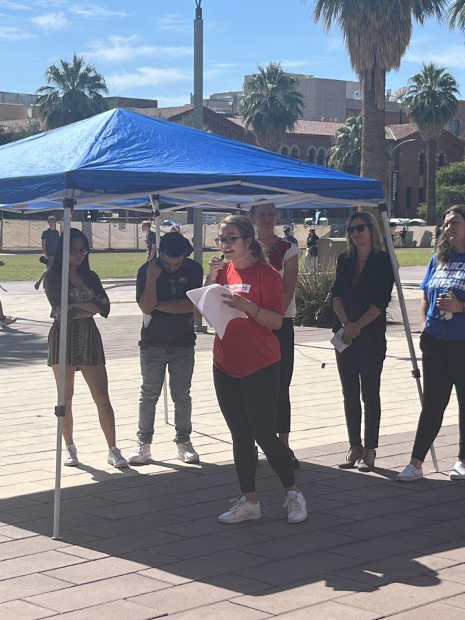 Mary Catherine Cline, a member of Students Demand Action, speaks at Fridays rally at the Alumni Plaza on the UA Mall. Behind Cline stand the other speakers.