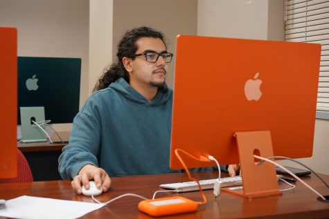 Jordan Chin, a senior in journalism and intern at Digital Futures Bilingual Studios, works on video editing projects. (Photo by Anto Chavez)