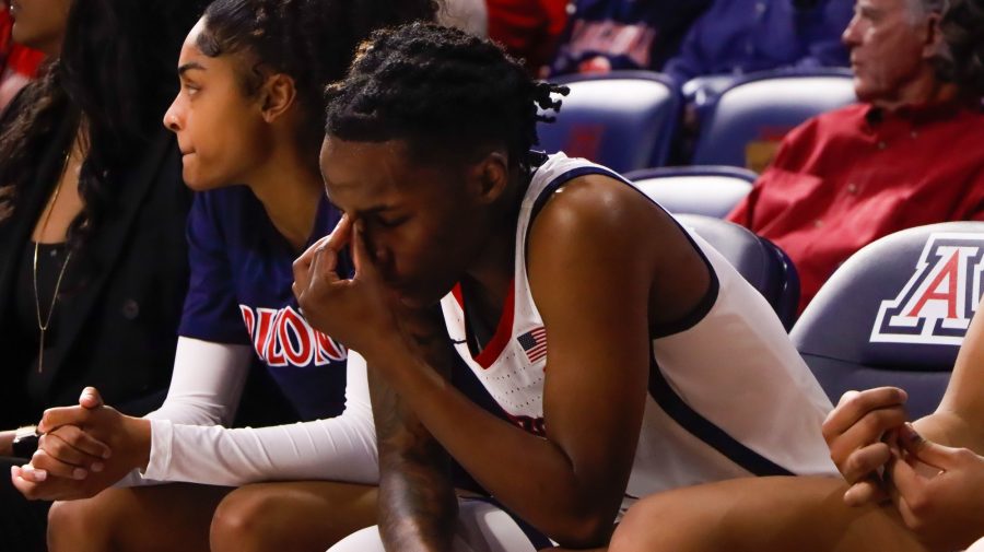 Shaina Pellington, a guard on the Arizona womans basketball team, holds her head while sitting on bench on Dec. 8, in McKale Center. The Wildcats would lose to the University of Kansas 50-77.